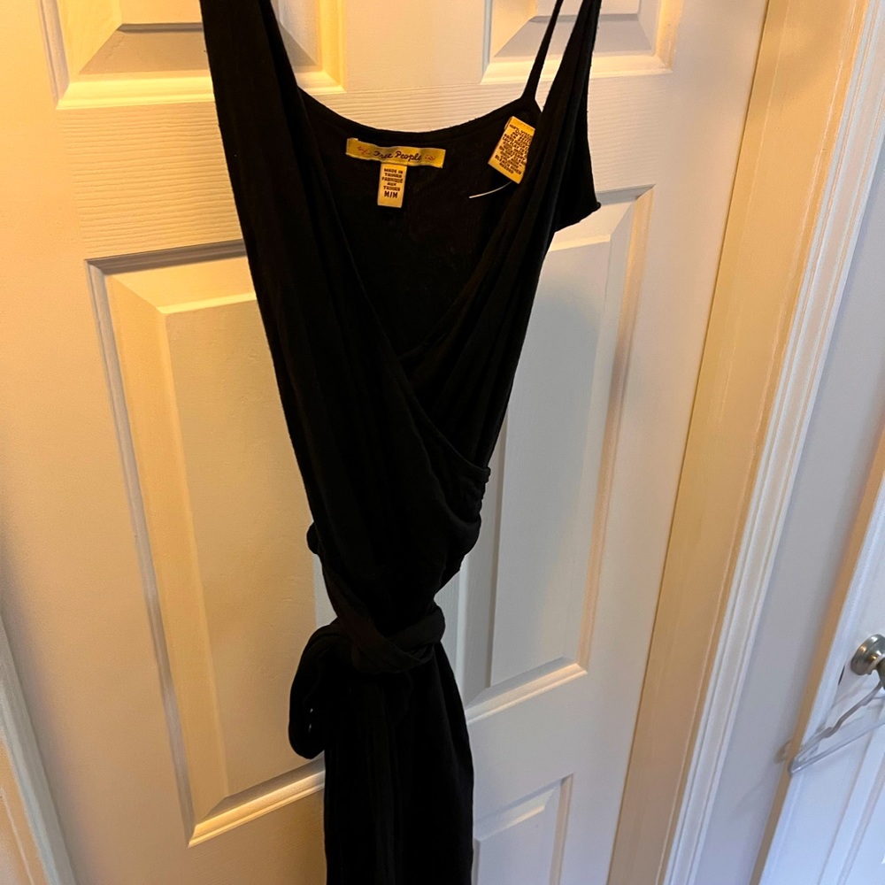 Black, low cut asymmetrical dress.